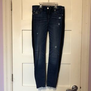 Dark wash ripped skinny jeans with black bands